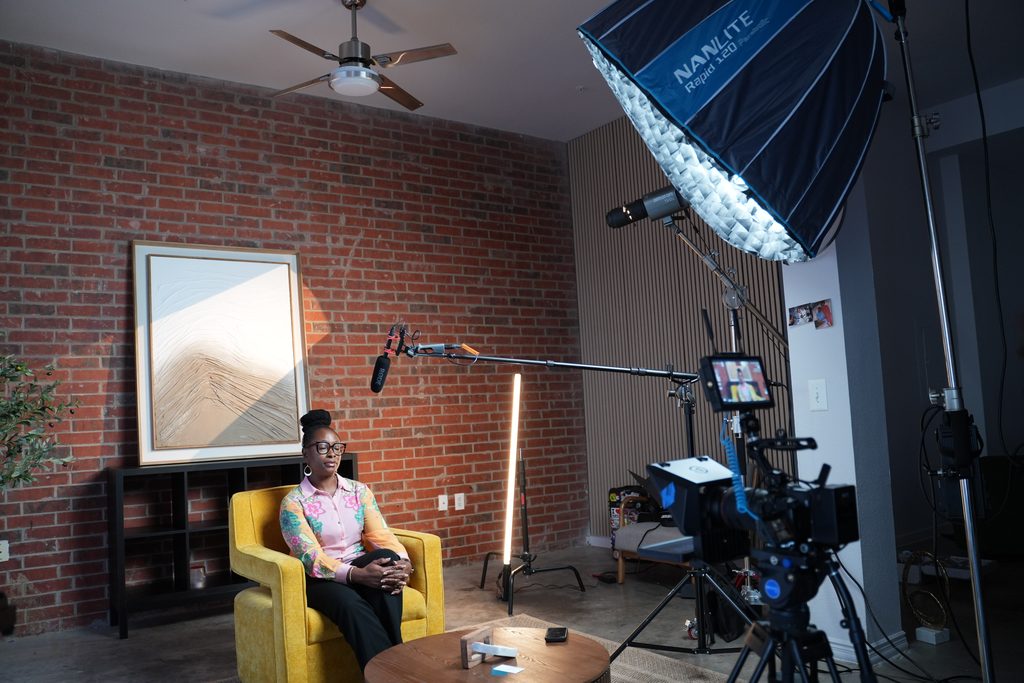 Nonprofit staff member being interviewed on camera inside Dlores Media Group's Plano video production studio