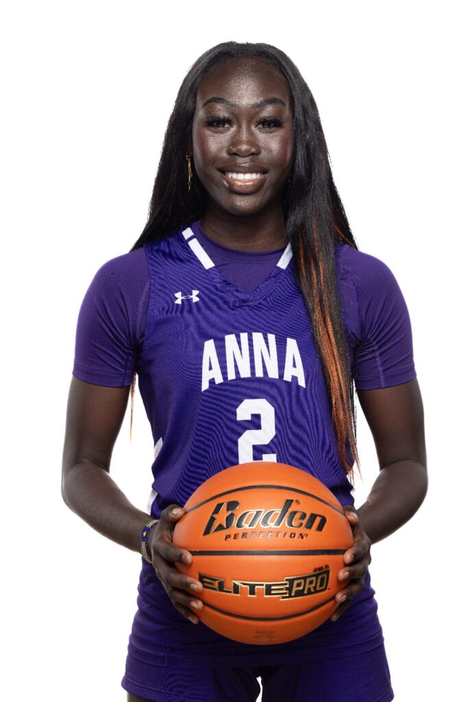 Girls basketball player in a purple number 2 Anna jersey holding a basketball